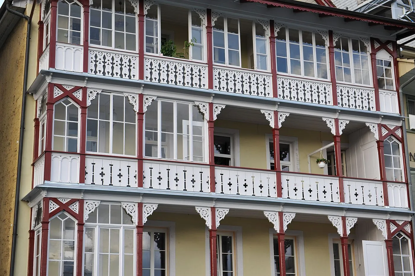 Holzbalkone eines Mehrfamilienhauses in Thun, weiss und rot gestrichen